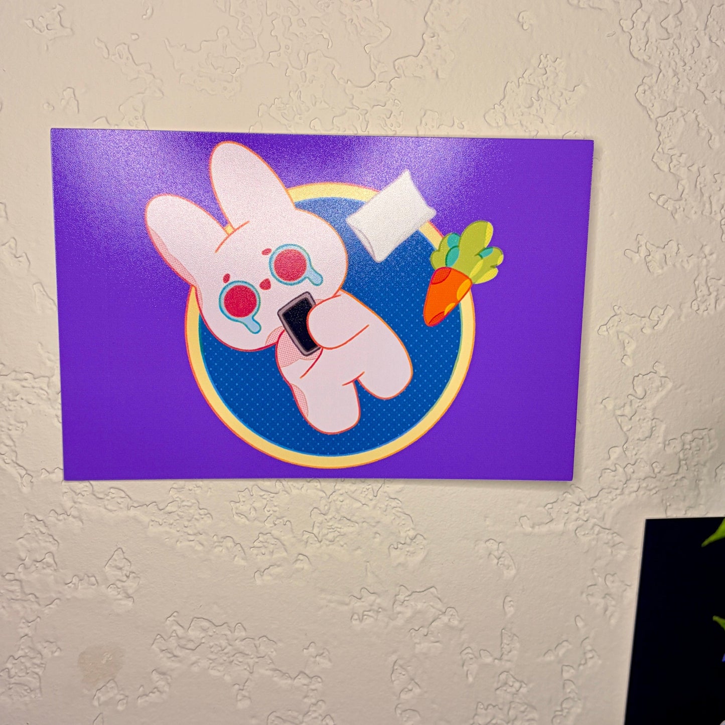 Cartoon character on a purple background attached to a white wall